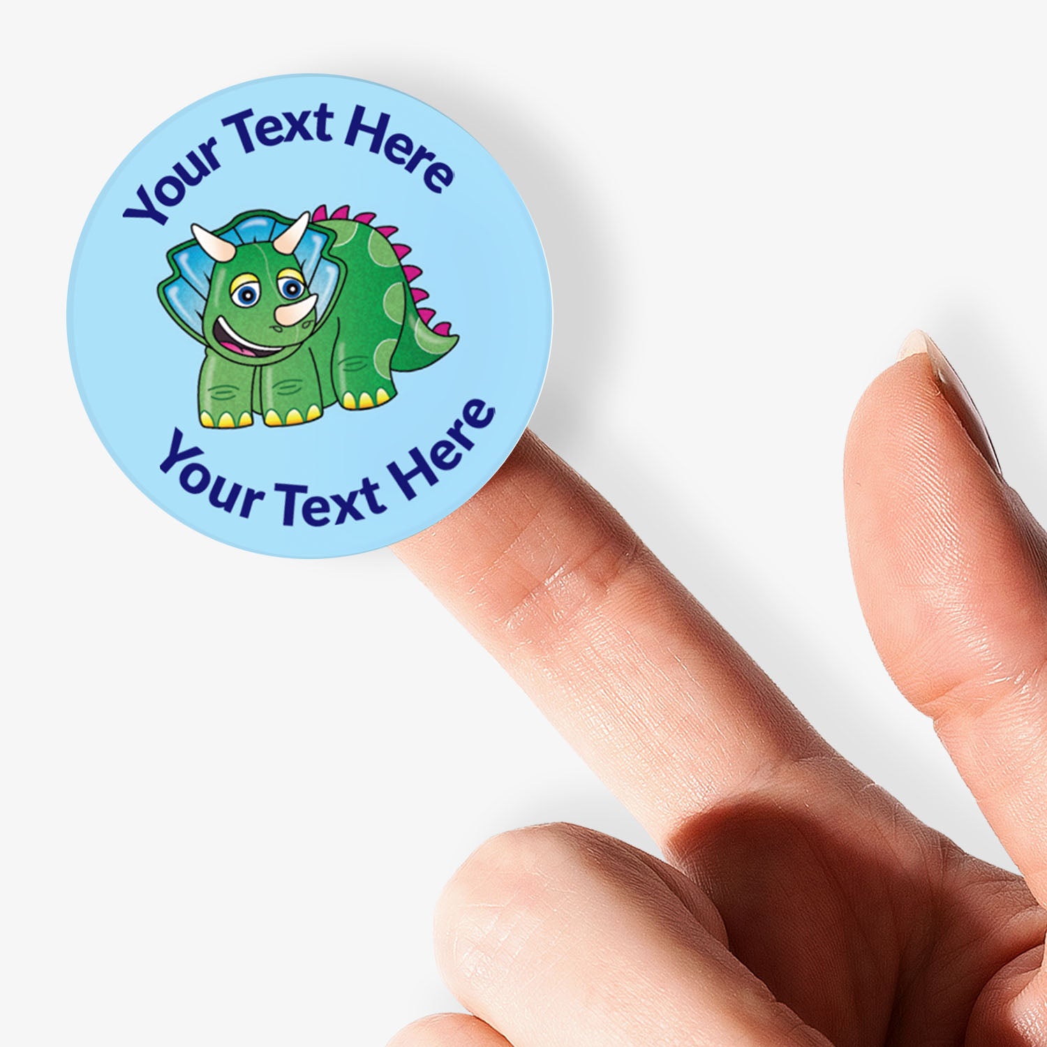 Round blue sticker with a dinosaur graphic and text space, held on finger.