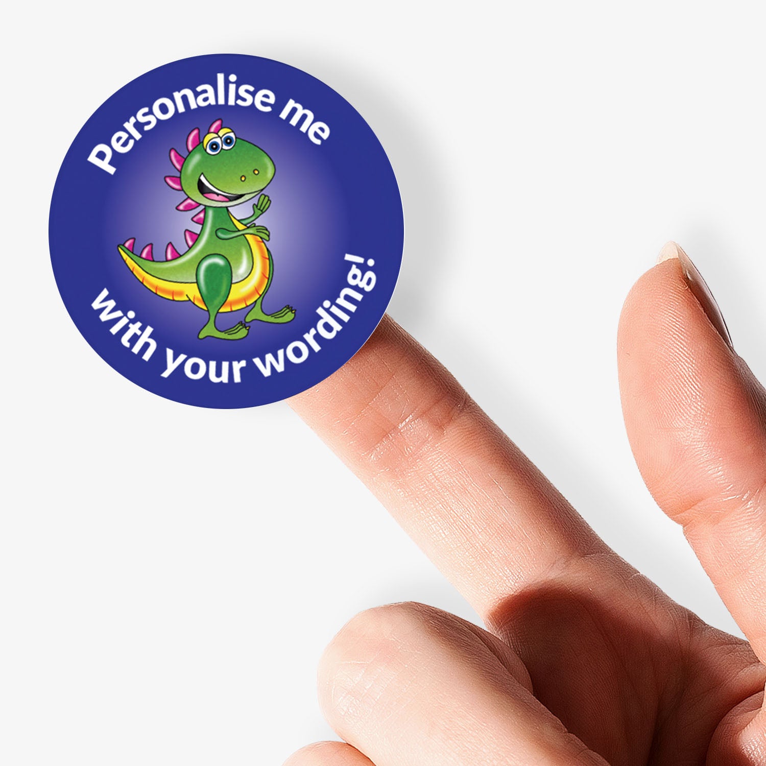 Round customizable sticker with a dinosaur design held by a finger.