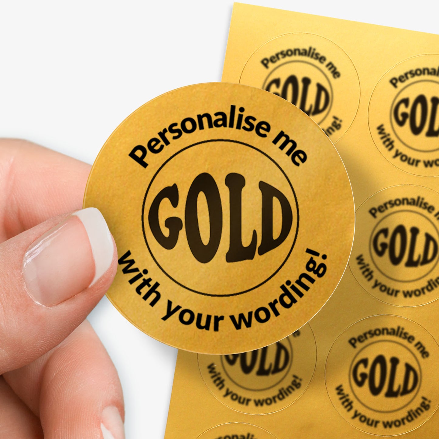 Personalised gold stickers with 'Personalise me with your wording!' text held by a hand.