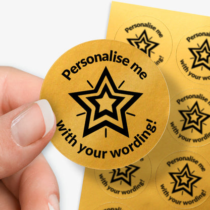 Personalised gold stickers with star design and text 'Personalise me with your wording!' held by a hand.
