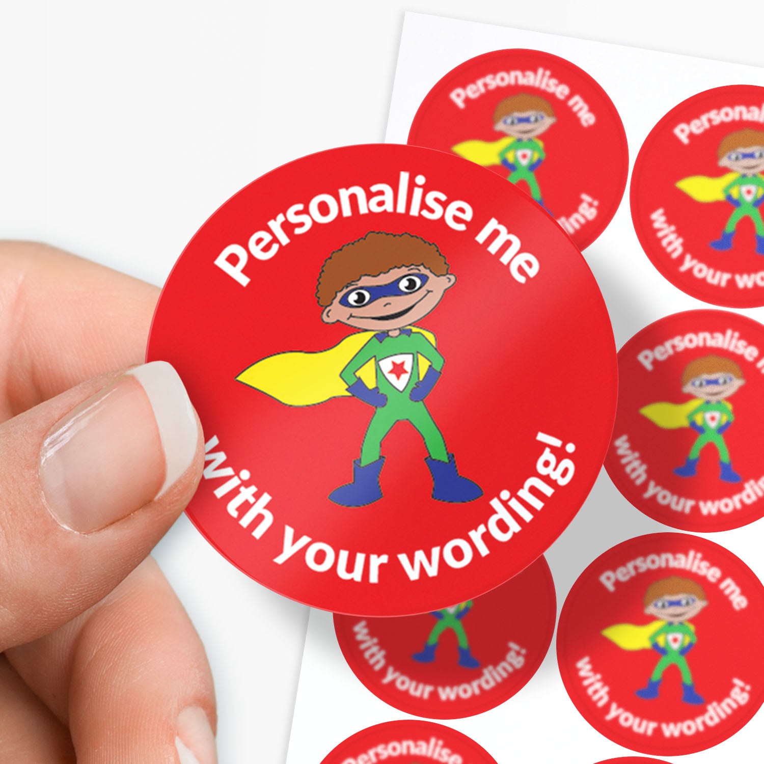 Red sticker with superhero design and text 'Personalise me with your wording!' held by a hand.