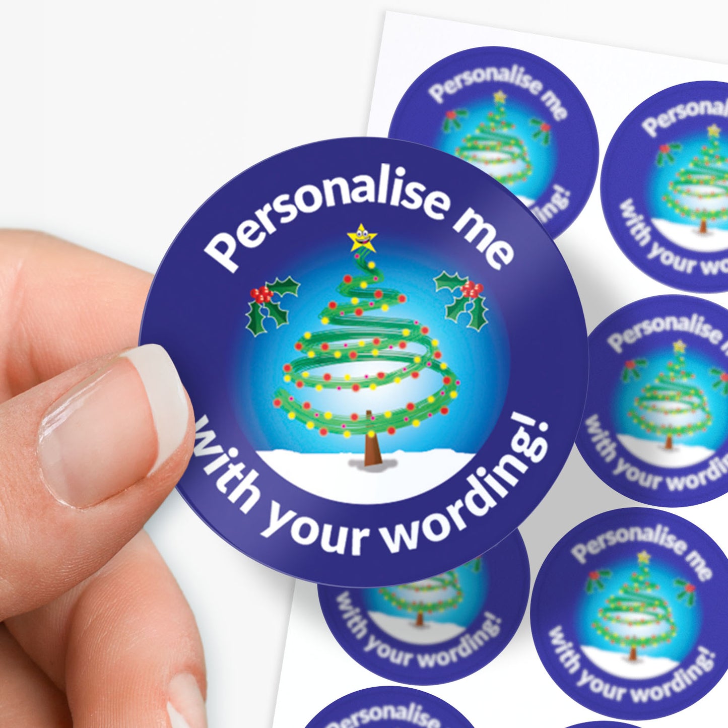 Hand holding a customizable Christmas tree sticker with 'Personalise me with your wording!' text.