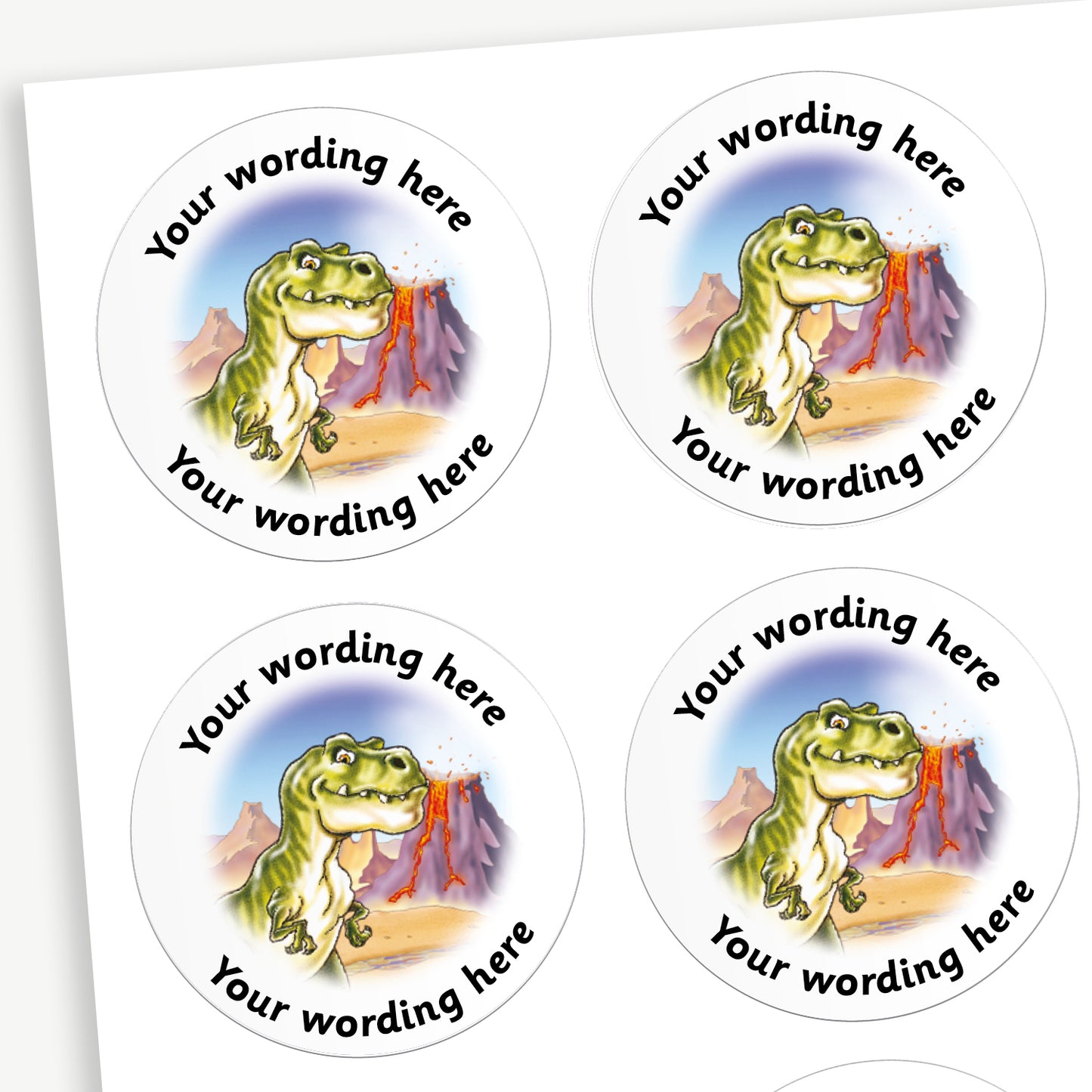 A sheet of white circular stickers featuring a illustrative T.Rex dinosaur with a volcano background; curving above and below the image is space for personalisation 'Your wording here' in a clear, bold font.
