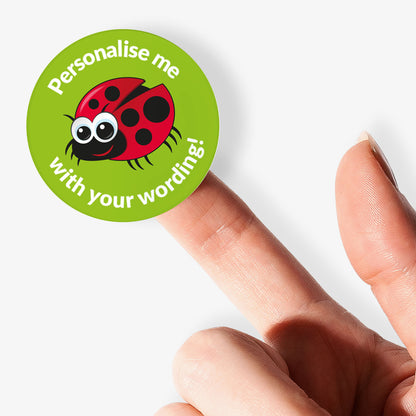 Round green sticker with a ladybug graphic and text on a finger