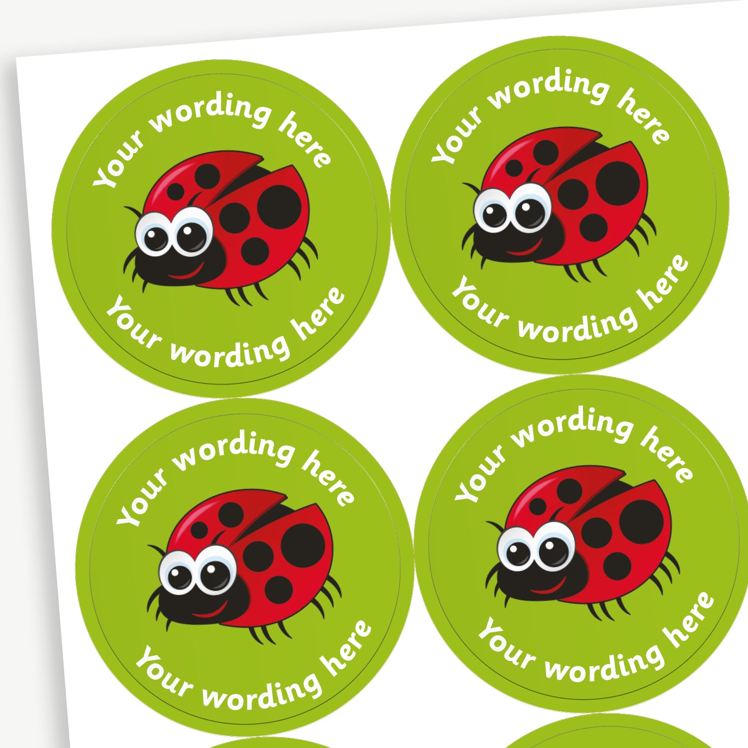 A sheet of green stickers featuring a central image of a cartoon ladybird.  Placeholder text 'Your wording here' is above and below the image.