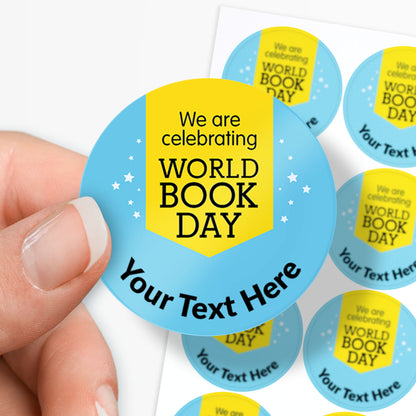 Round sticker with 'We are celebrating World Book Day' text held by a hand, with more stickers in the background.