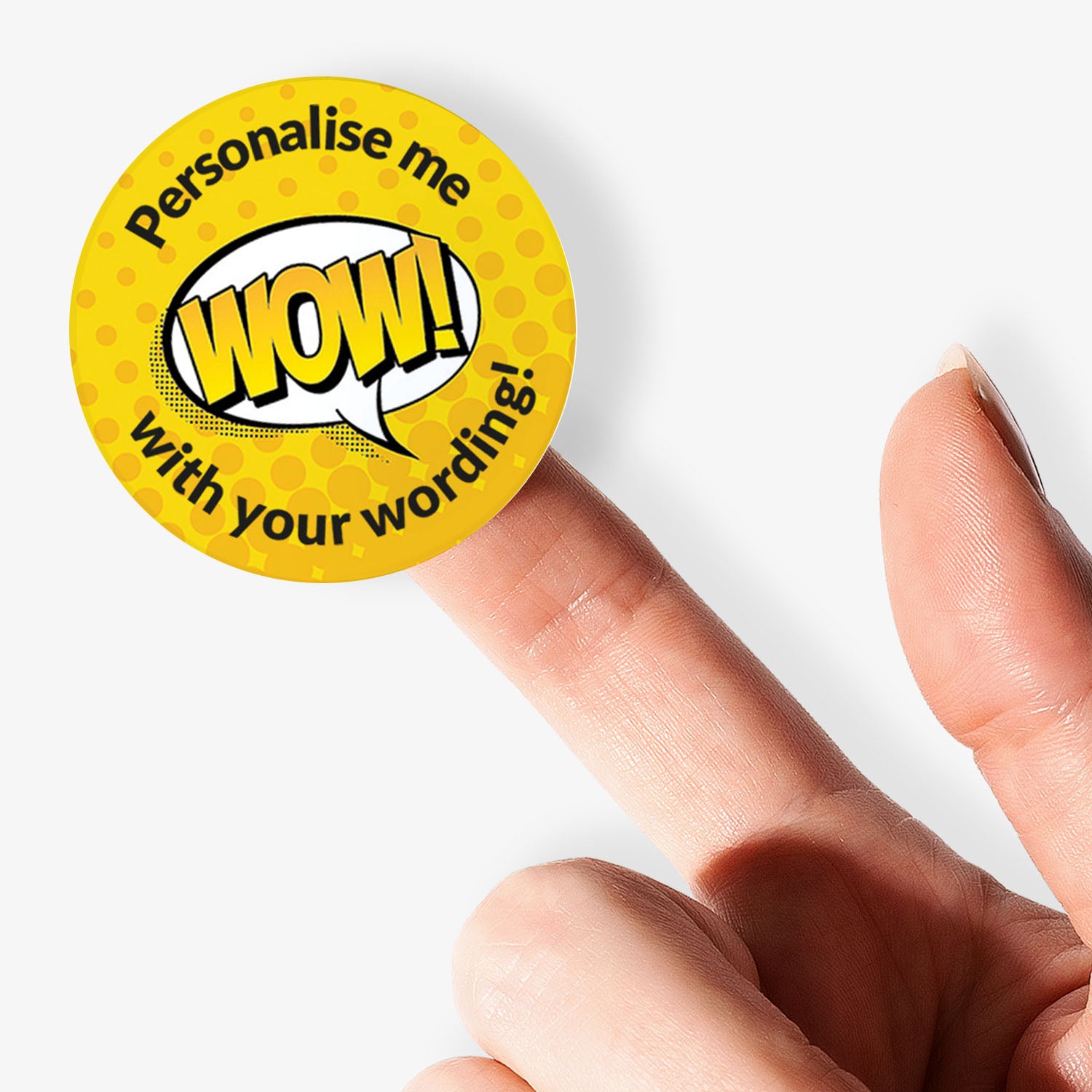 Yellow button with 'WOW!' text and 'Personalise me' text, held by a finger on a white background