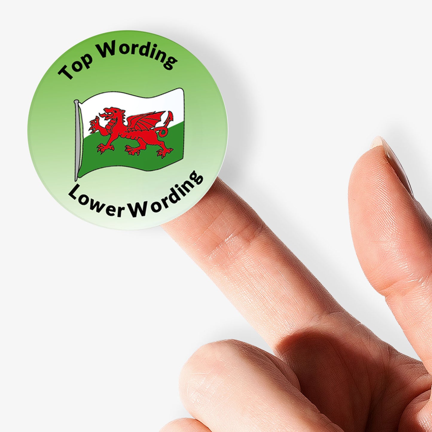 Circular sticker with a red dragon on a white background, held by a finger against a light gray background.