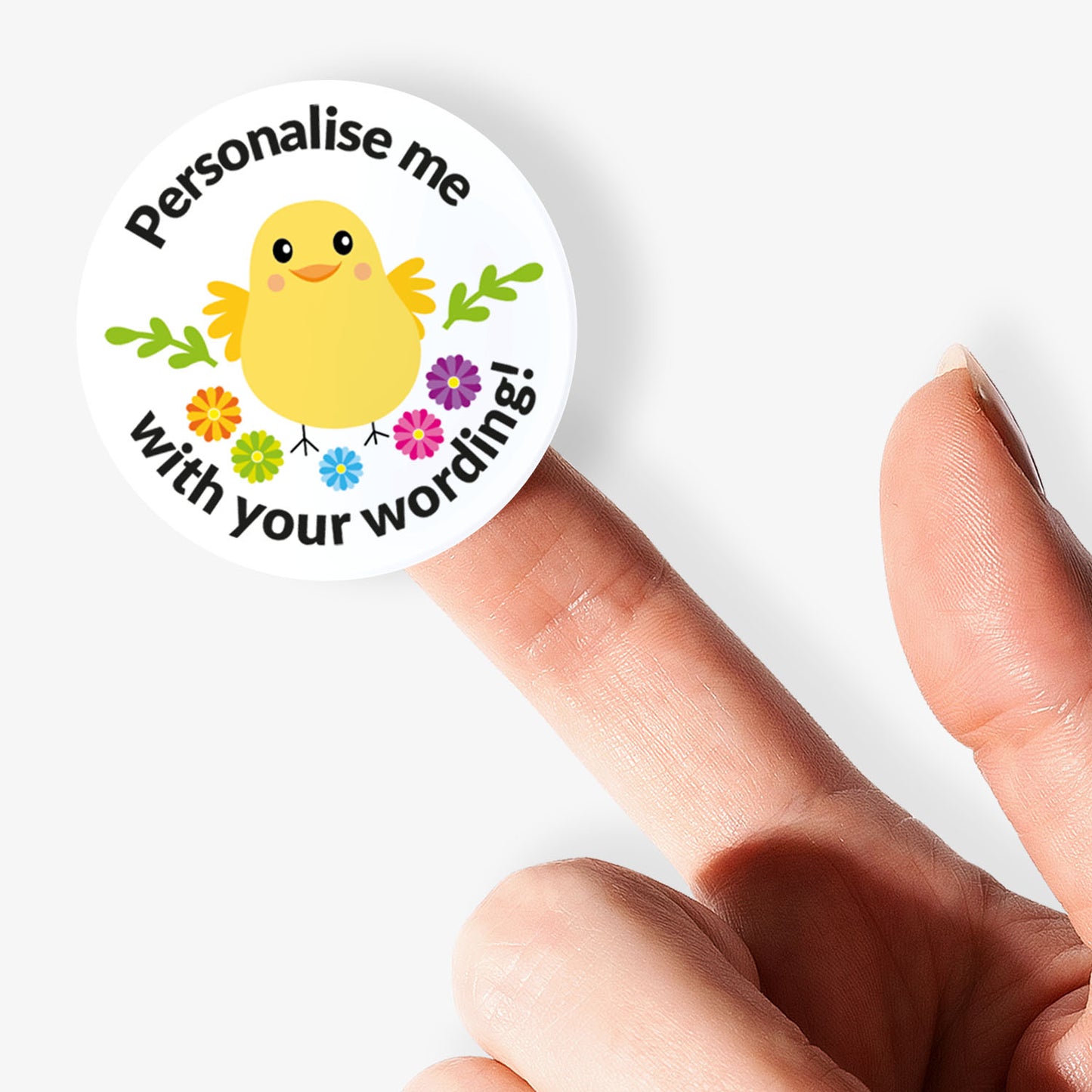 Round sticker with a chick illustration and text 'Personalise me with your wording!' held between fingers.