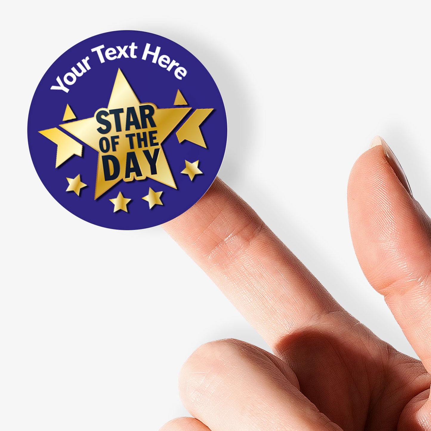 Personalisable 'Star of the Day' sticker held on a finger on a white background