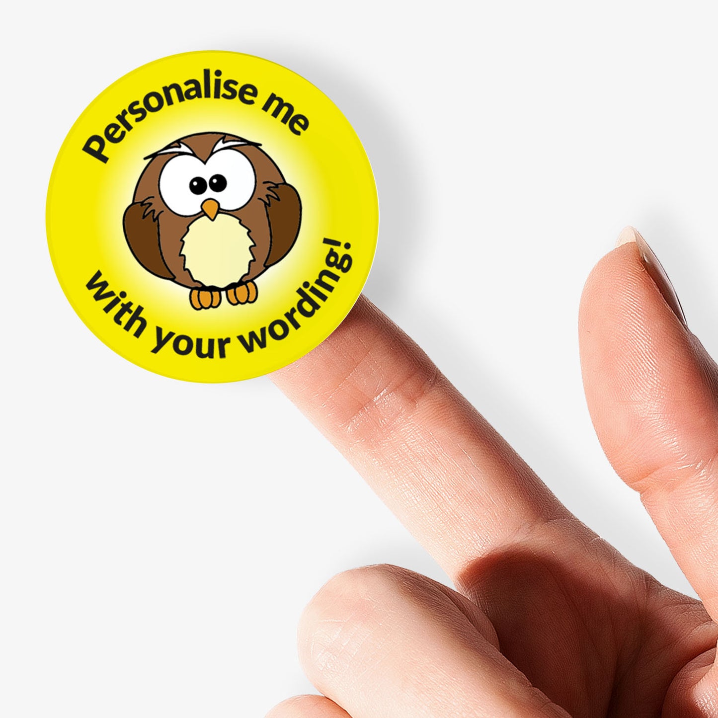 Yellow sticker on a finger with an owl as the central image.  Space for personalisation above and below the image.