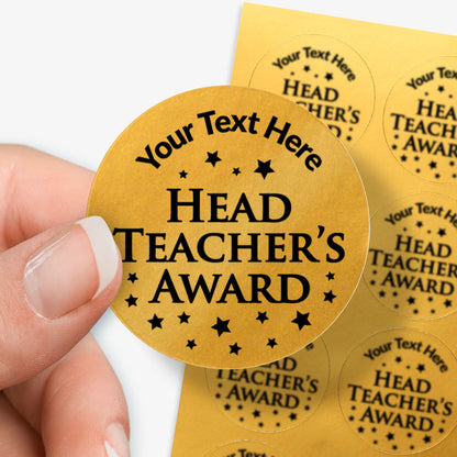 Gold circular award stickers with 'Your Text Here HEAD TEACHER'S AWARD' text held by a hand.
