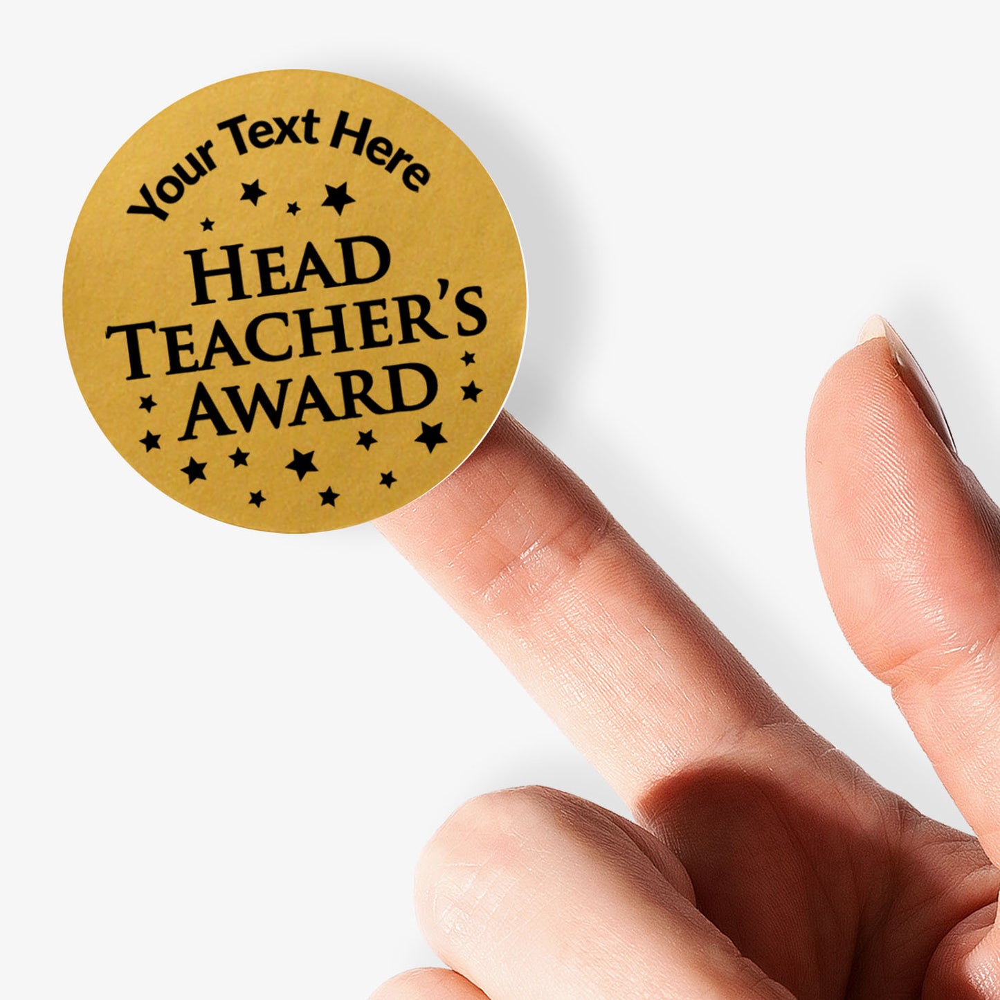 Round 'Head Teacher's Award' stickers with customisable text on a gold background held by a hand.
