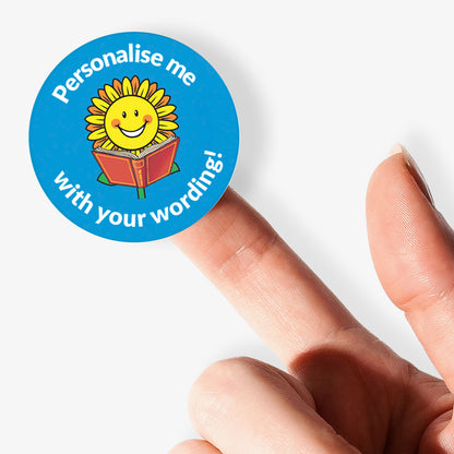 Blue sticker on a finger with a smiling sunflower reading a book as a central image.  Space for personalisation above and below the image.