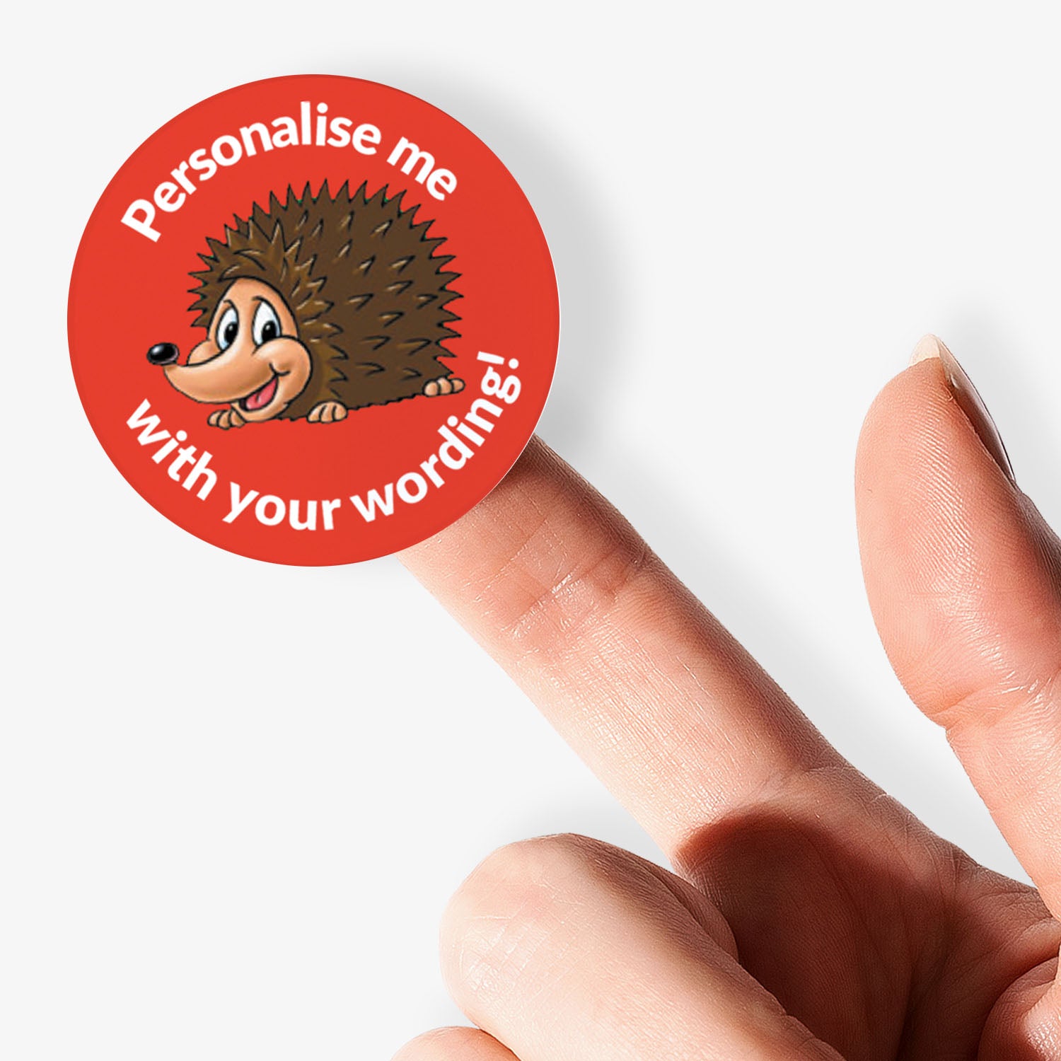 Red sticker on a finger with a smiling hedgehog as a central image.  Space for personalisation above and below the image.