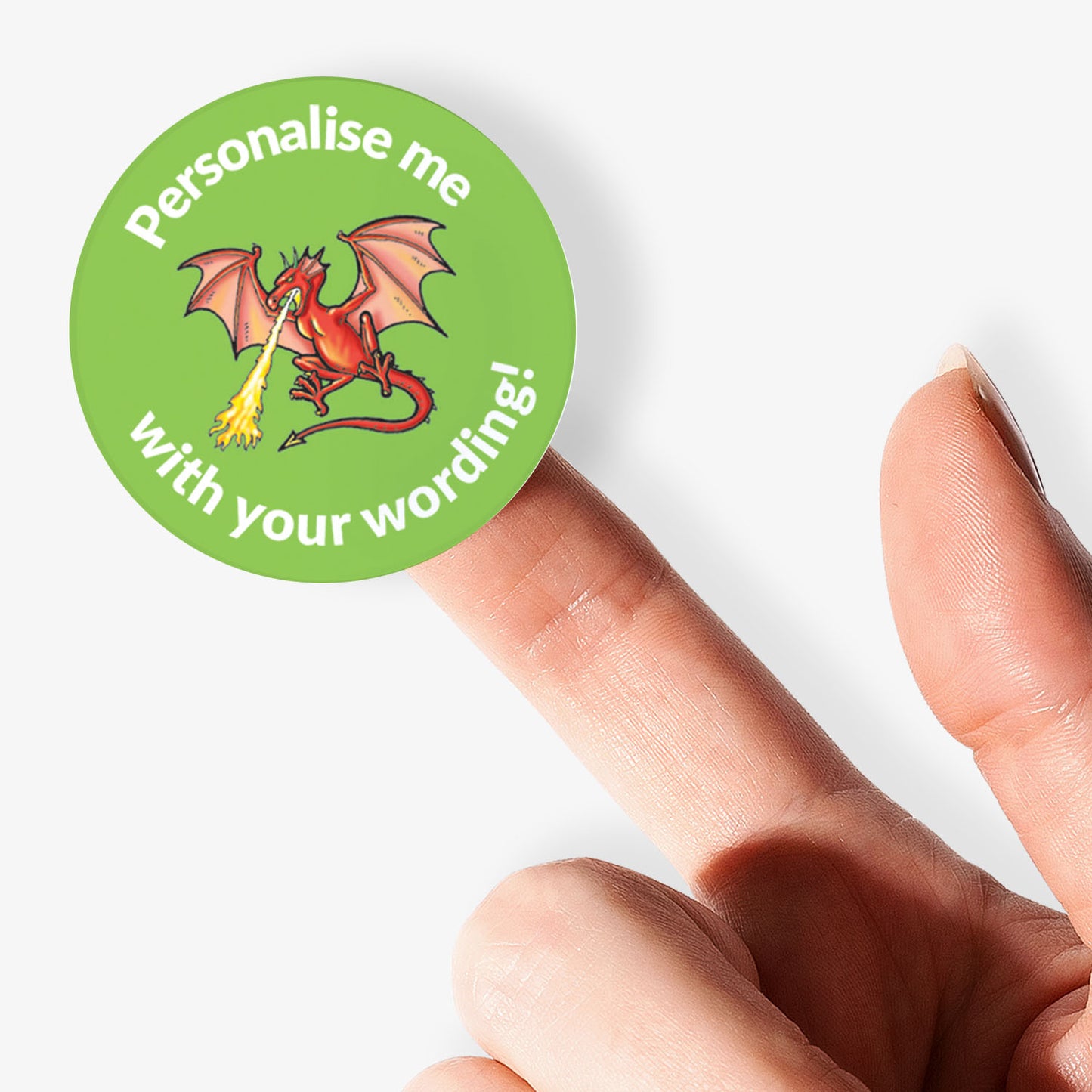 Green sticker, on a finger, with a fire breathing dragon as the central image.  Space for personalisation above and below the image.