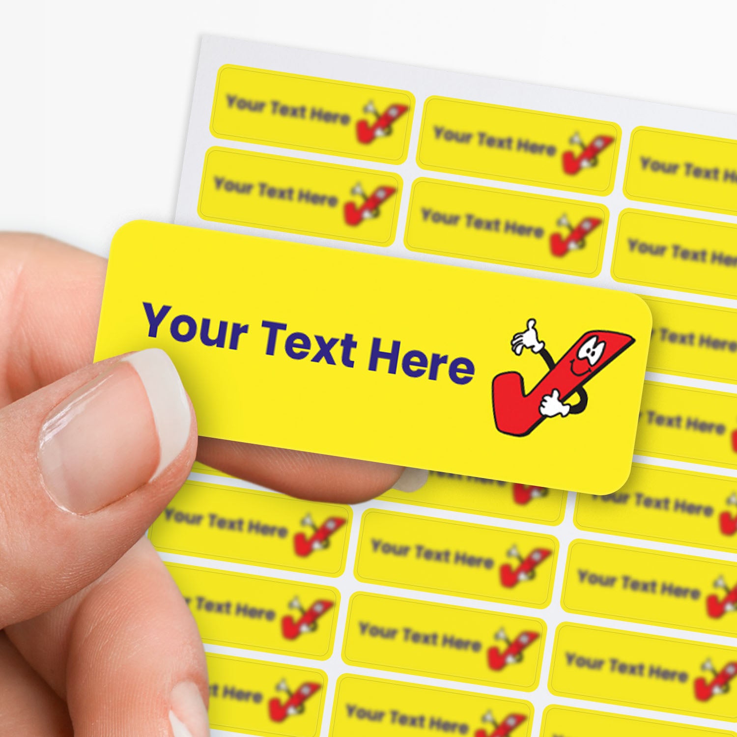 Yellow label with cartoon pencil character and customizable text area held by hand with sheet of sticker in the background.