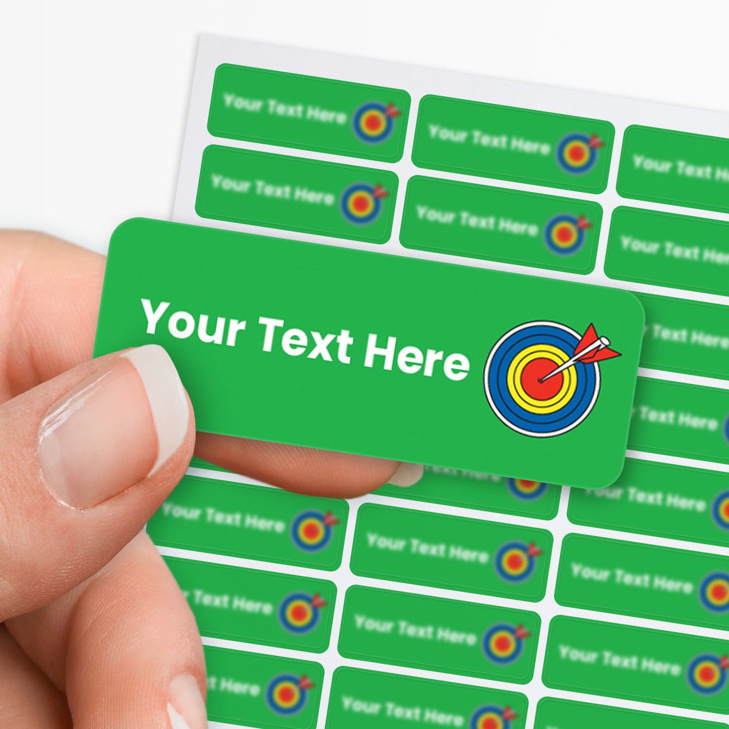 Green stickers with white text and an arrow and target icon held by a hand.