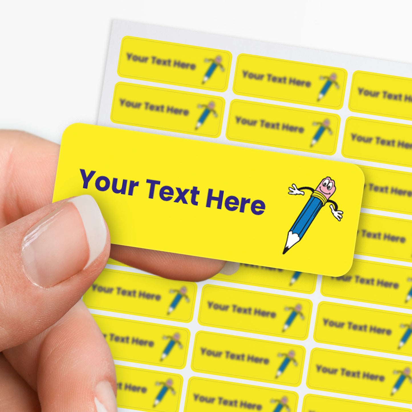 Yellow label with cartoon pencil character and customizable text area held by hand with sticker sheet in the background.