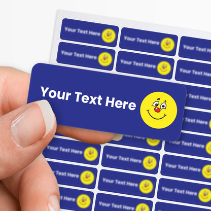 Blue stickers with white text and a yellow smiley icon held by a hand with a sheet in the background