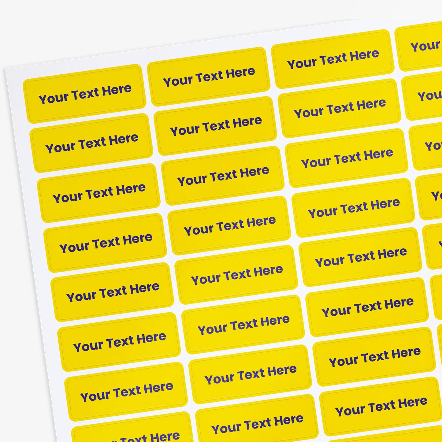 Sheet of yellow labels with 'Your Text Here' text on a white background
