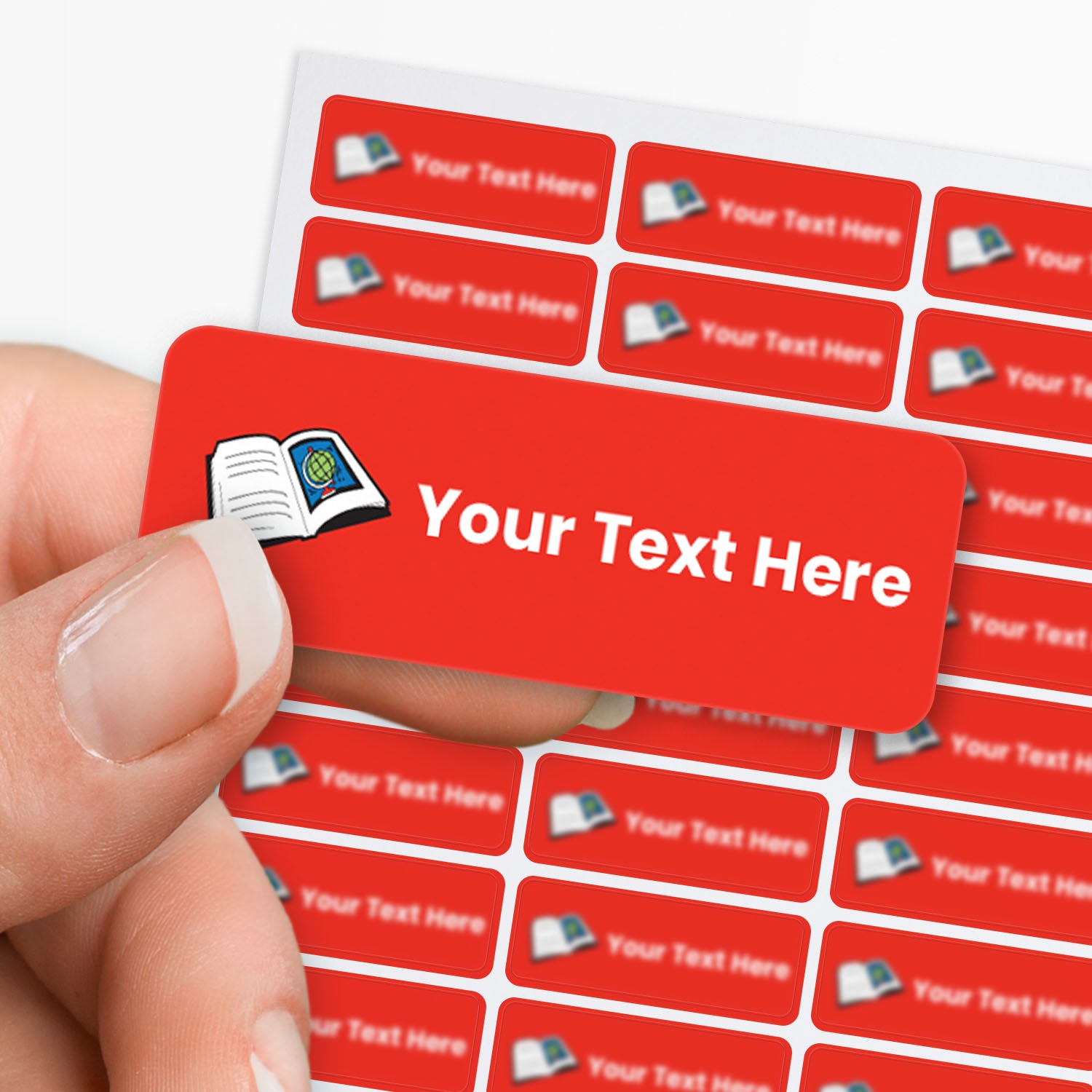 Red stickers with white text and a book icon held by a hand, with a sheet of stickers in the background.