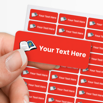 Red stickers with white text and a book icon held by a hand, with a sheet of stickers in the background.