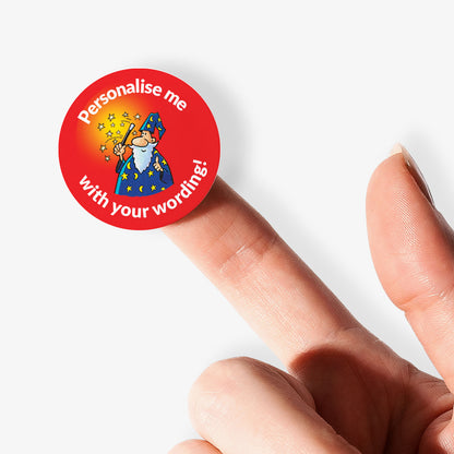 Red sticker on finger with a smiling wizard and wand as a central image.  'Personalise me with your wording!' 