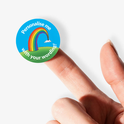 Sticker on a finger with a rainbow  as a central image.  'Personalise me with your wording!' surrounds the image.