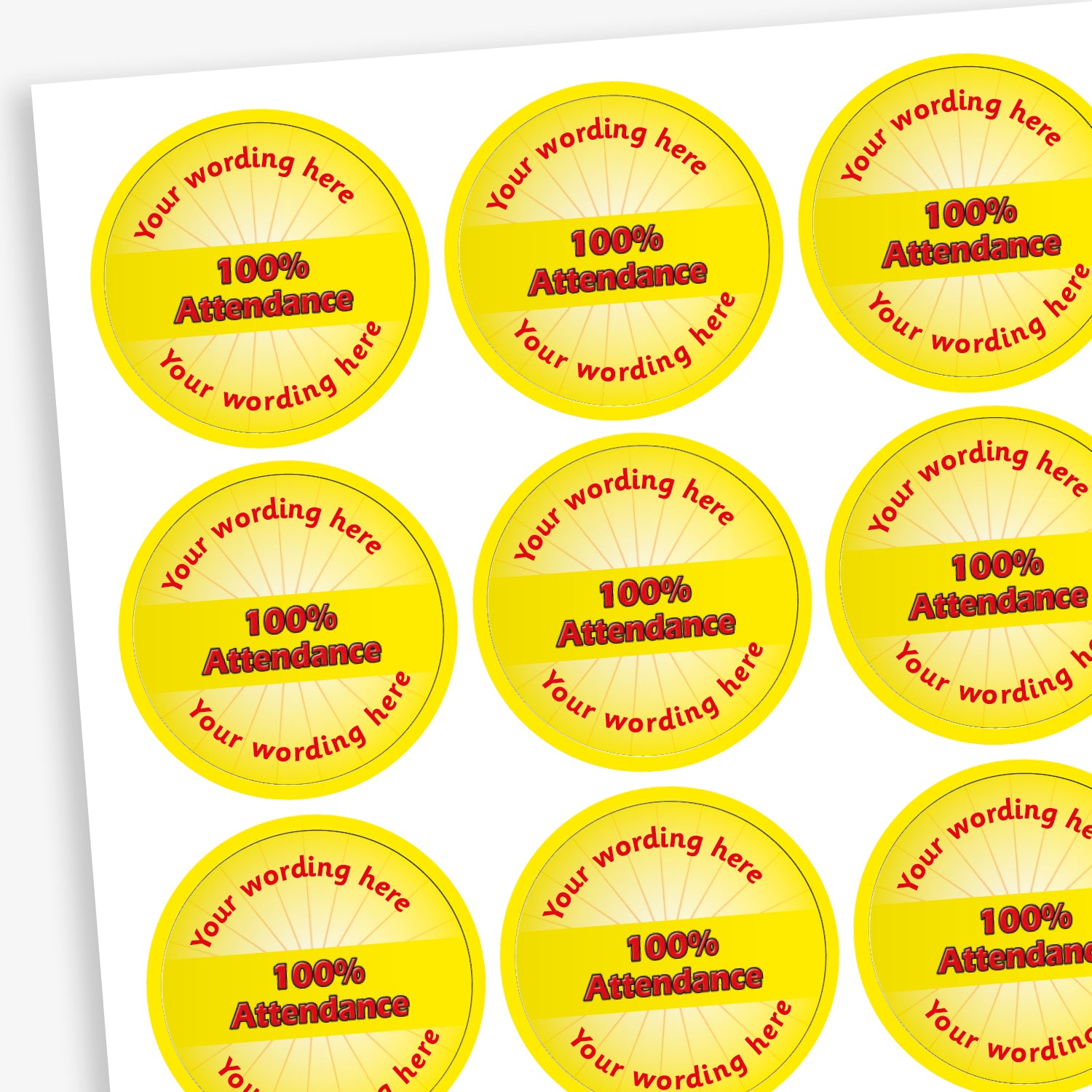 Sheet of 70 round, yellow stickers, each 25mm in diameter, featuring bold yellow text reading '100% Attendance' at the centre. Surrounding the central text is placeholder wording 'Your wording here' above and below, indicating customisable areas for personalised messages.