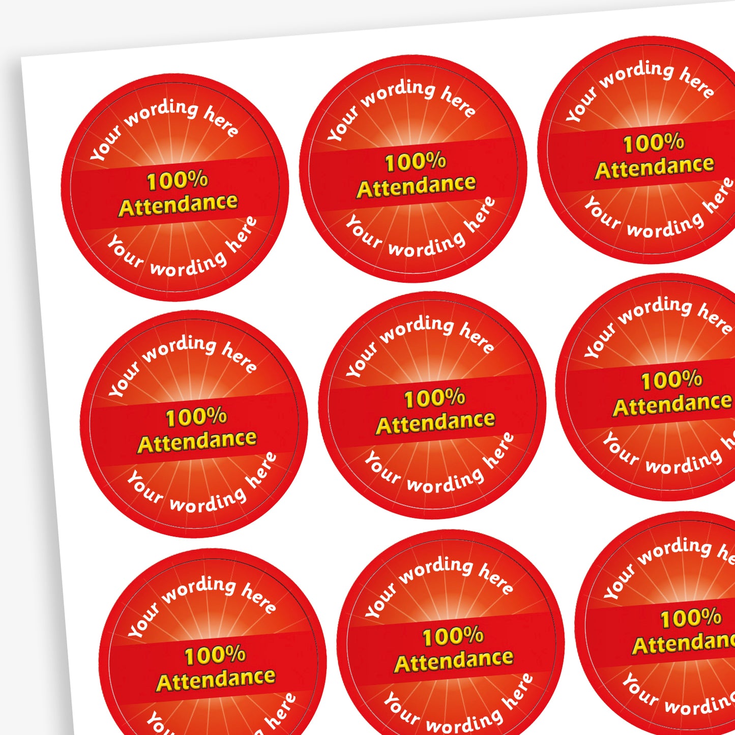Sheet of 70 round, red stickers, each 25mm in diameter, featuring bold yellow text reading '100% Attendance' at the centre. Surrounding the central text is placeholder wording 'Your wording here' above and below, indicating customisable areas for personalised messages.