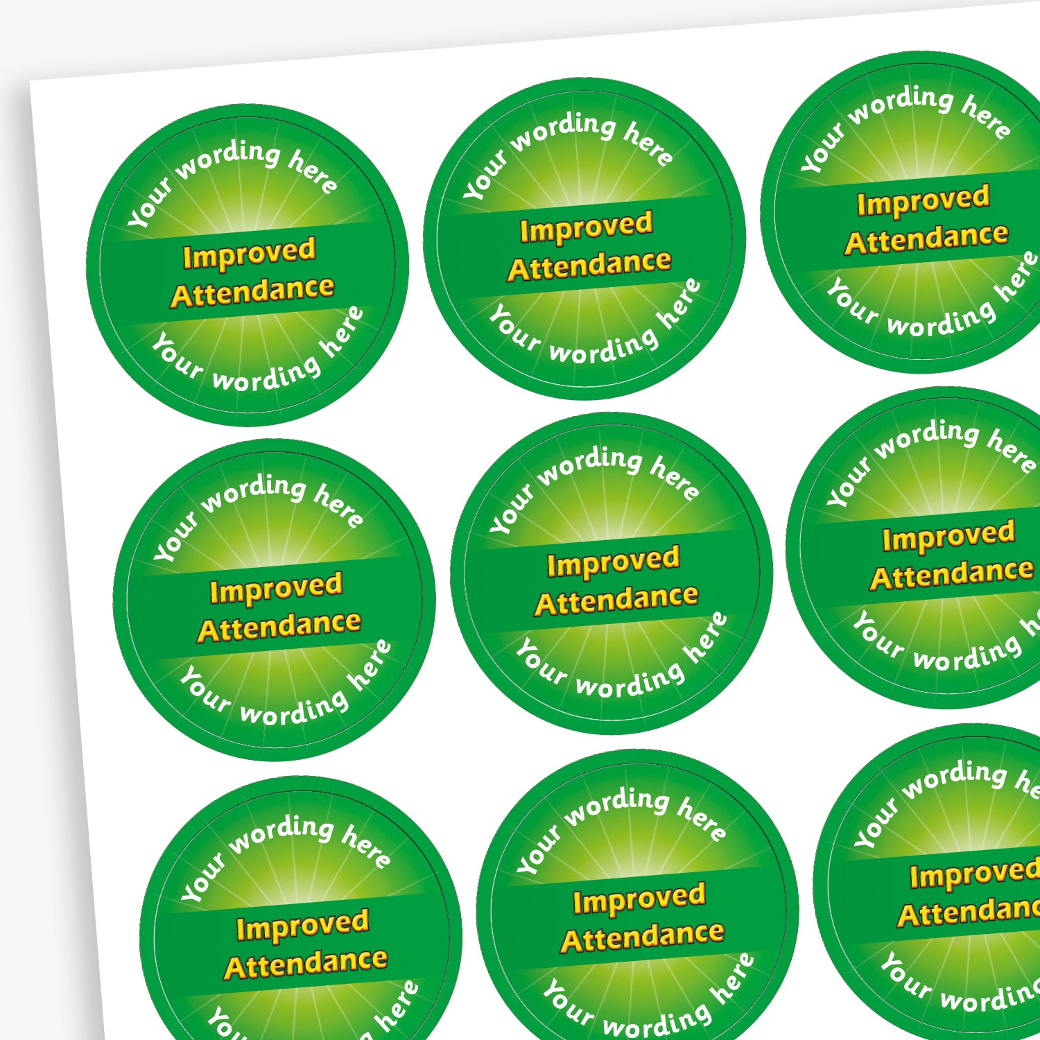 Sheet of 70 personalised 'Improved Attendance' stickers, each 25mm in diameter, featuring a green circular design with the text 'Improved Attendance' in bold yellow letters and space for custom wording above and below, ideal for recognising pupils' attendance improvements.