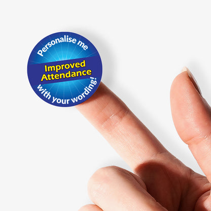 Blue sticker on finger with 'Improved Attendance' in a starburst as a central image.  'Personalise me with your wording!' surrounds the image.