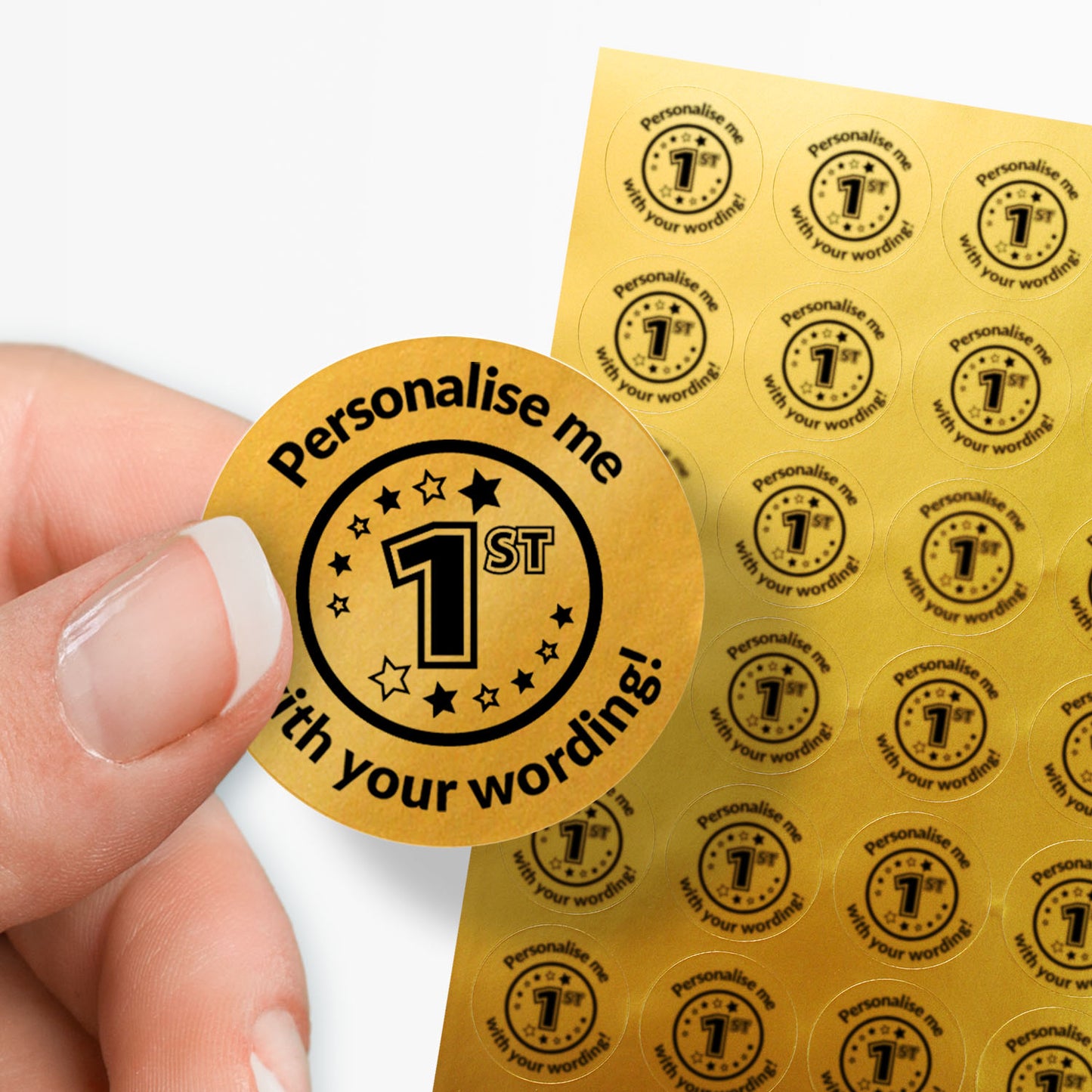 Sheet of circular stickers with 1st  in the middle and text on a gold background. Single sticker held between thumb and finger