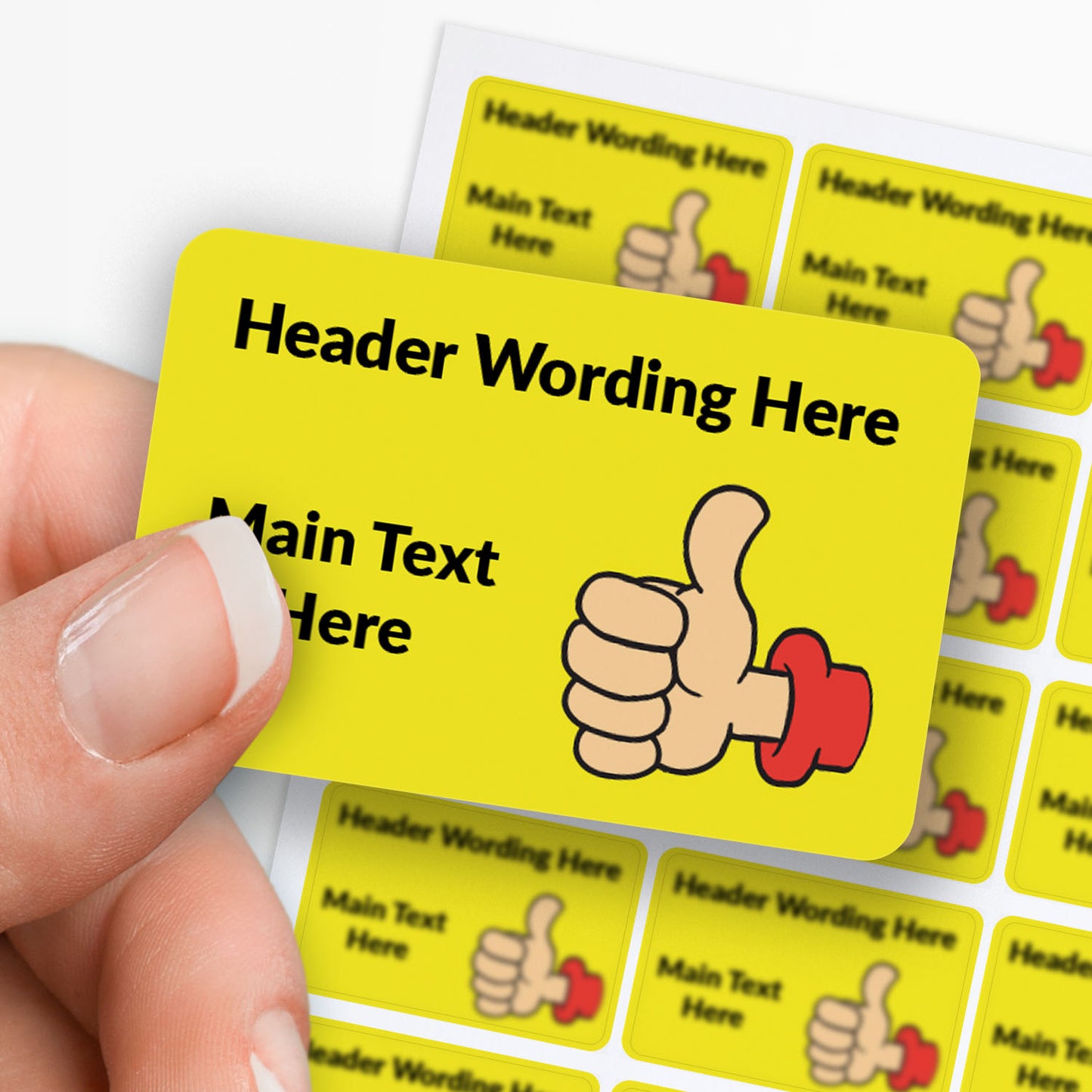 Rectangle yellow sticker with thumbs up decals and text. held between finger and thumb