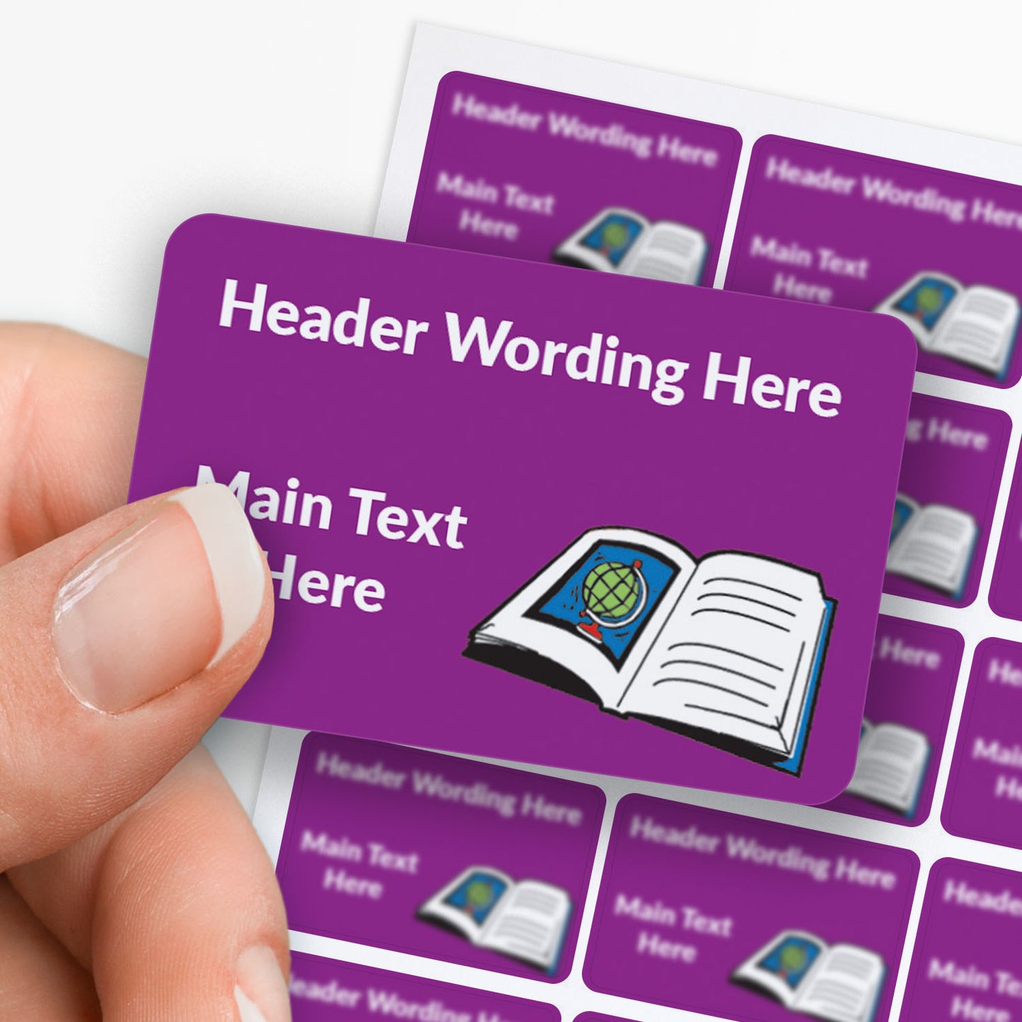 Purple stickers with white text and a book icon held by a hand with a sheet of stickers in the background