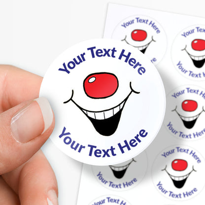 Circular sticker with a clown face design and customizable text held by a hand.