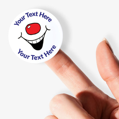 Circular sticker with smiley face design held by a finger on a white background