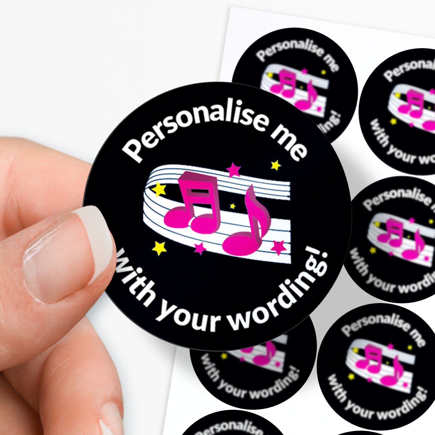 Round sticker with musical notes and text 'Personalise me with your wording!' held between finger and thumb.