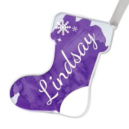 Personalised Christmas stocking-shaped acrylic decoration with the name 'Lindsay' written in white script on a purple background, featuring a snowflake design, placed on a white surface.