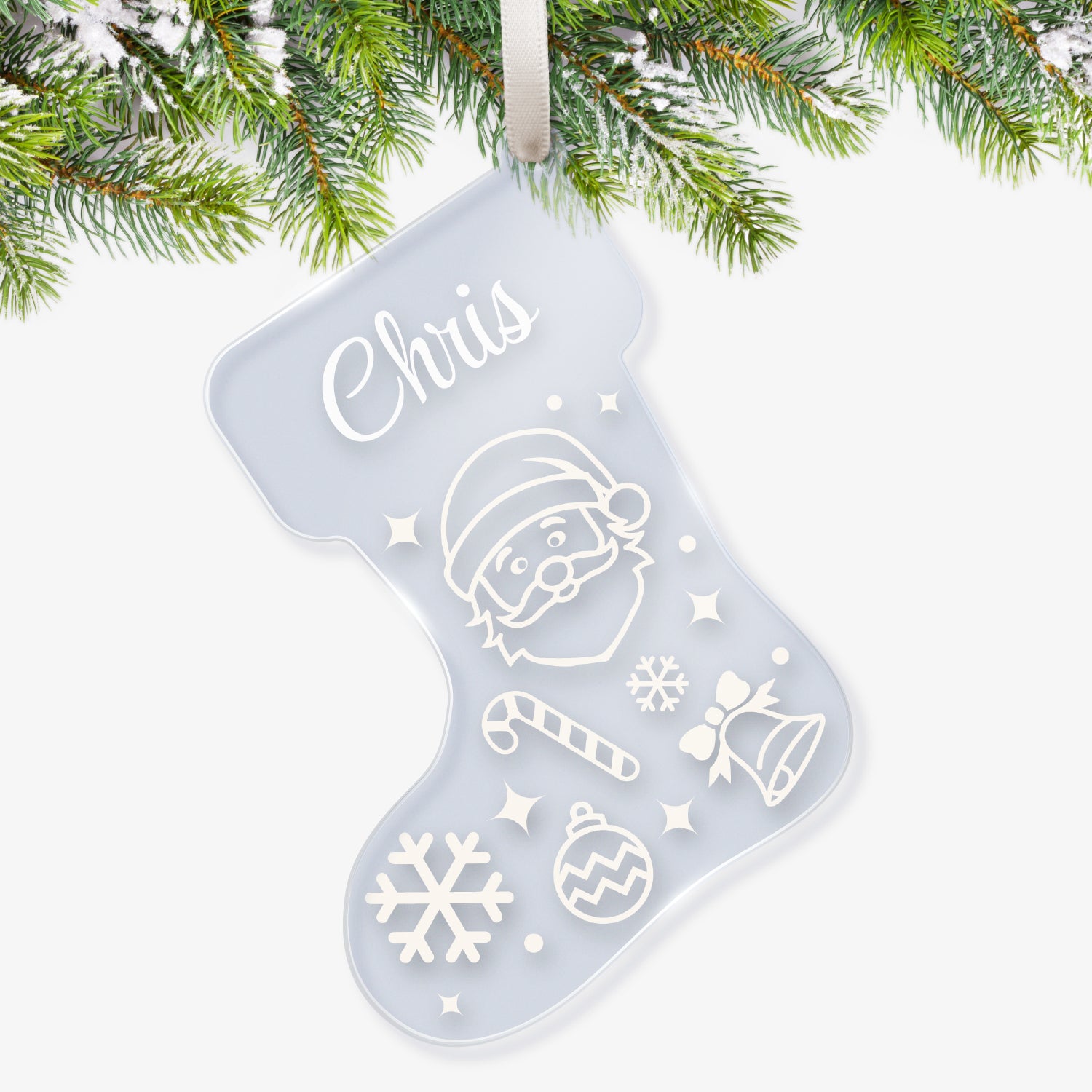 Clear acrylic Christmas stocking-shaped tree ornament decorated with white snowflakes, Father Cristmas, candy cane, bell and bauble, featuring a space at the top for a customisation saying 'Chris' in white script, hanging on a Christmas tree.
