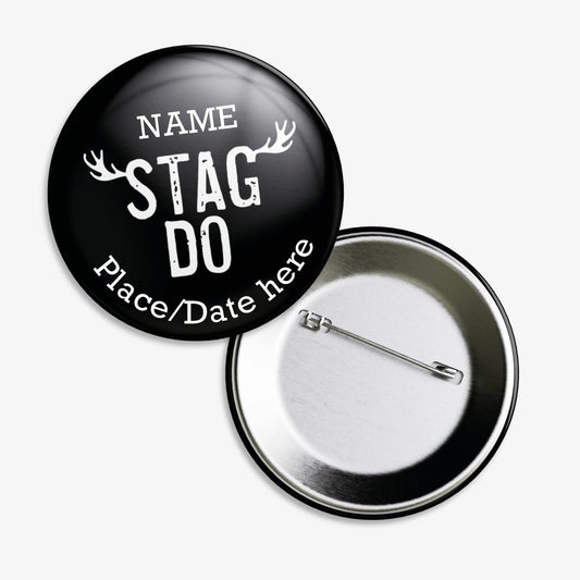 A set of ten 38mm round badges with a black background, featuring the phrase "STAG DO" in bold white capital letters at the centre, flanked by stylised white antlers; customisable white text areas are positioned above and below the central design, and the badge includes a safety pin backing.