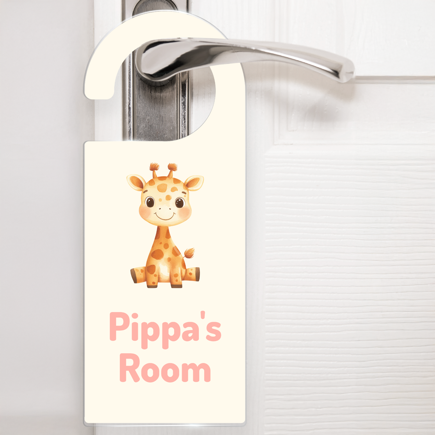 A cream door hanger hanging on a silver handle, featuring a cute cartoon giraffe above the text 'Pippa's Room' in soft pink letters. The design is playful and child-friendly, ideal for decorating a child's bedroom door.