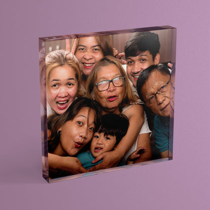 A square acrylic photo block featuring a photo of a generational family photo.  The block has a glossy, freestanding design ideal for display.