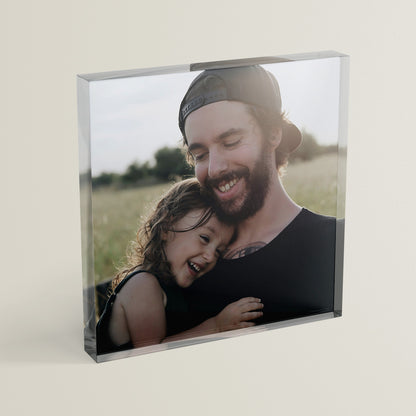 A square acrylic photo block featuring a photo of a father and daughter in a field.  The block has a glossy, freestanding design ideal for display.