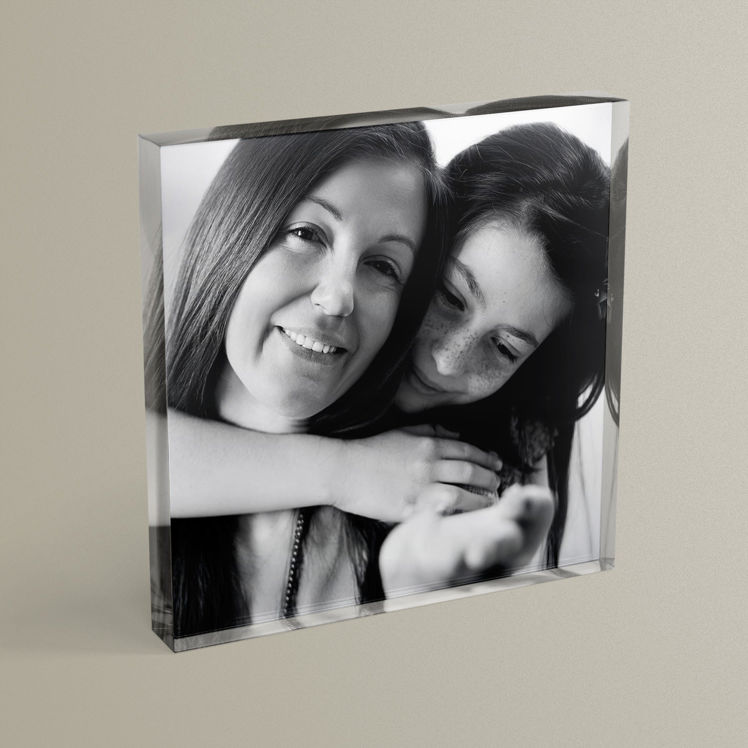 A square acrylic photo block featuring a black & white photo of a mother and daughter.  The block has a glossy, freestanding design ideal for display.