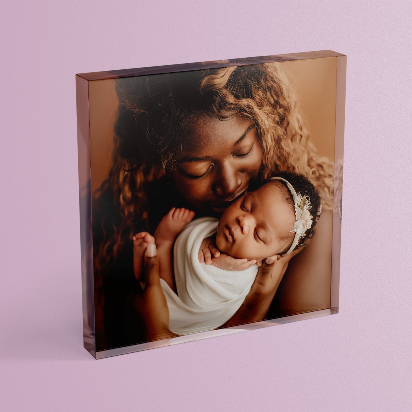 A square acrylic photo block featuring a photo of a mother and new born child.  The block has a glossy, freestanding design ideal for display.