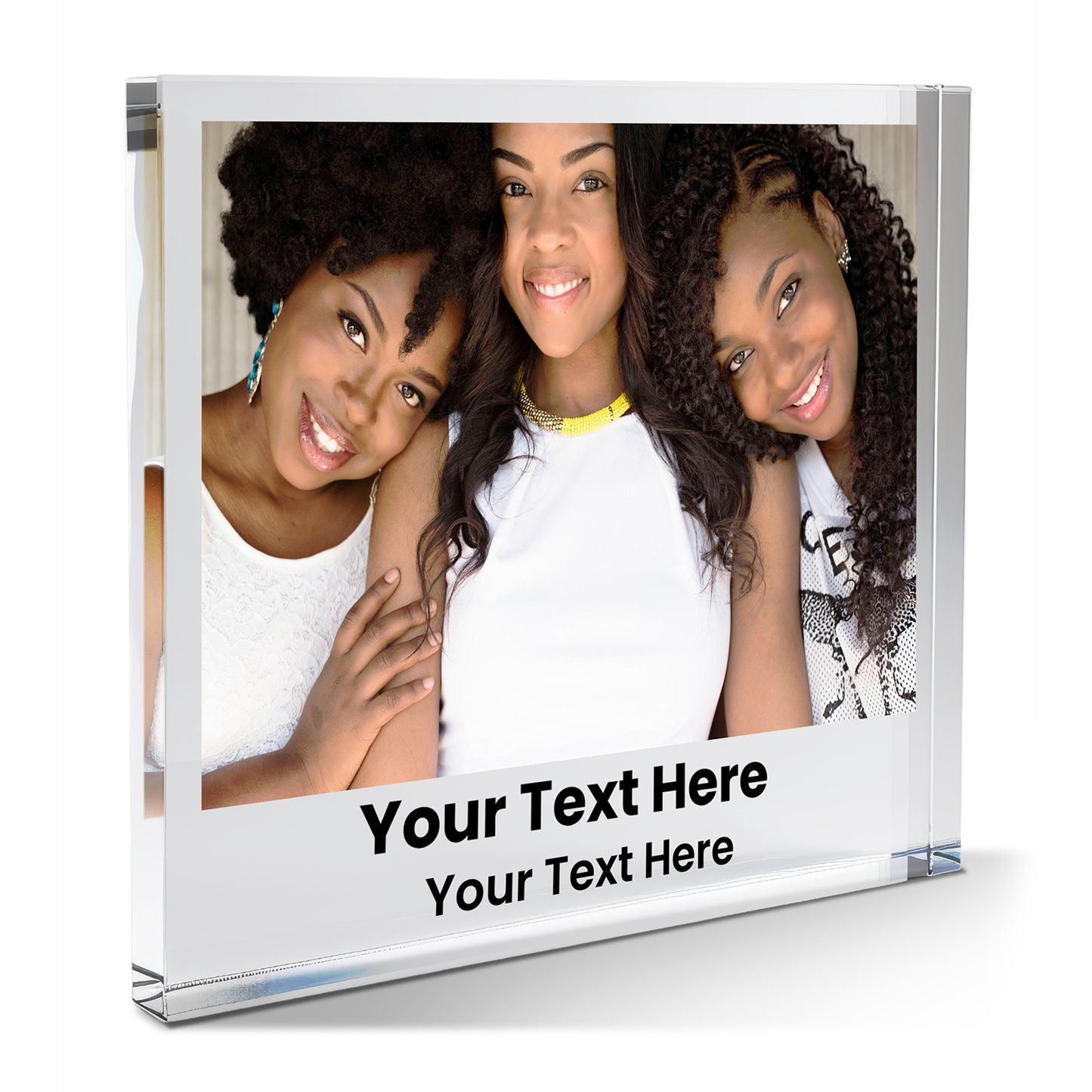A square acrylic photo block featuring a friends photo. The image shows three friends together. Beneath the photo, printed placeholder text reads 'Your Text Here' followed by  'Your Text Here'. The block has a glossy, freestanding design ideal for display.