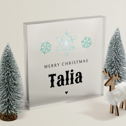 Framed Christmas card with snowflakes and 'Merry Christmas Talia' text, surrounded by decorative trees and a deer.