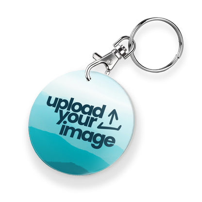 A personalised keyring featuring a circular photo frame design with a metal keychain and clasp. The photo a cyan mountain background overlaid with an 'Upload your Image' icon. 